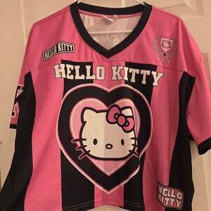 Sanrio Hello Kitty Pink and Black Striped Graphic Football Skimmer Jersey
